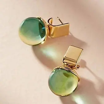 Modern earrings with a sparkling green crystal stone