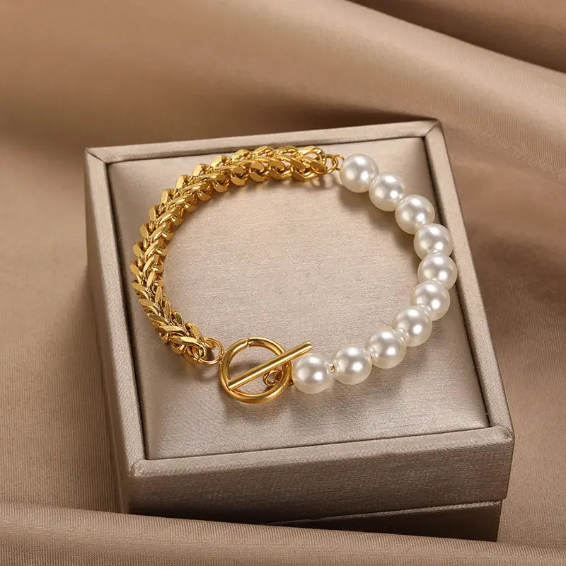 An elegant bracelet featuring sparkling pearls and a braided link chain