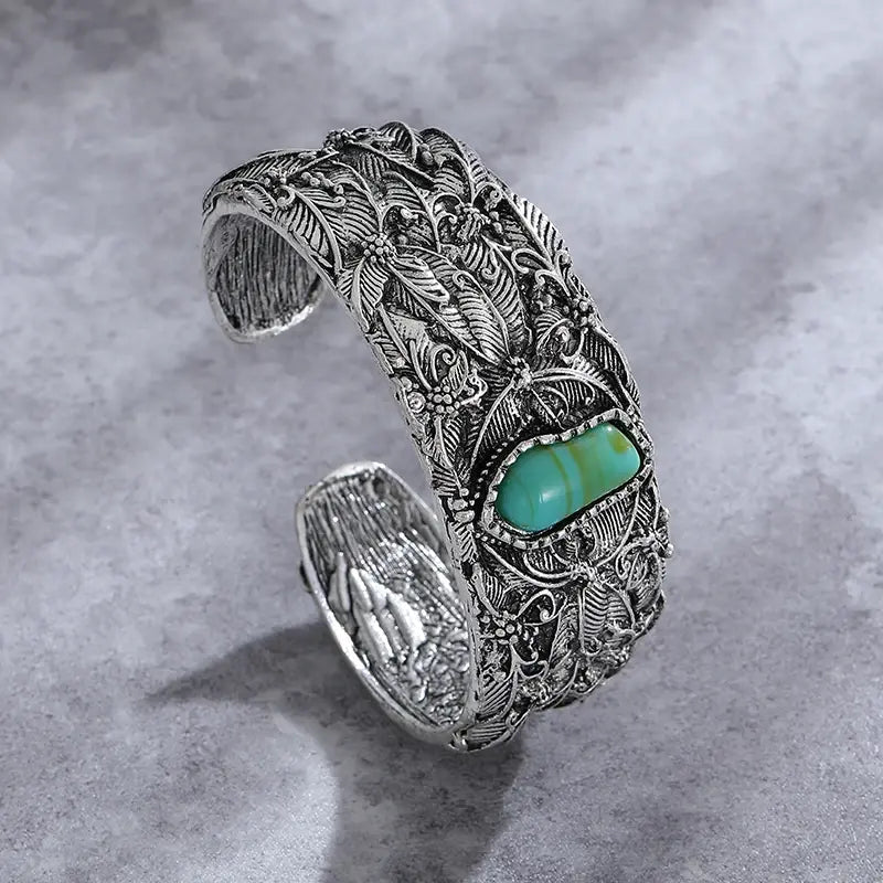 Vintage turquoise bracelet with detailed foliage engraving and an open design
