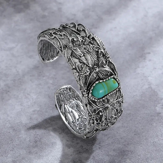 Vintage turquoise bracelet with detailed foliage engraving and an open design