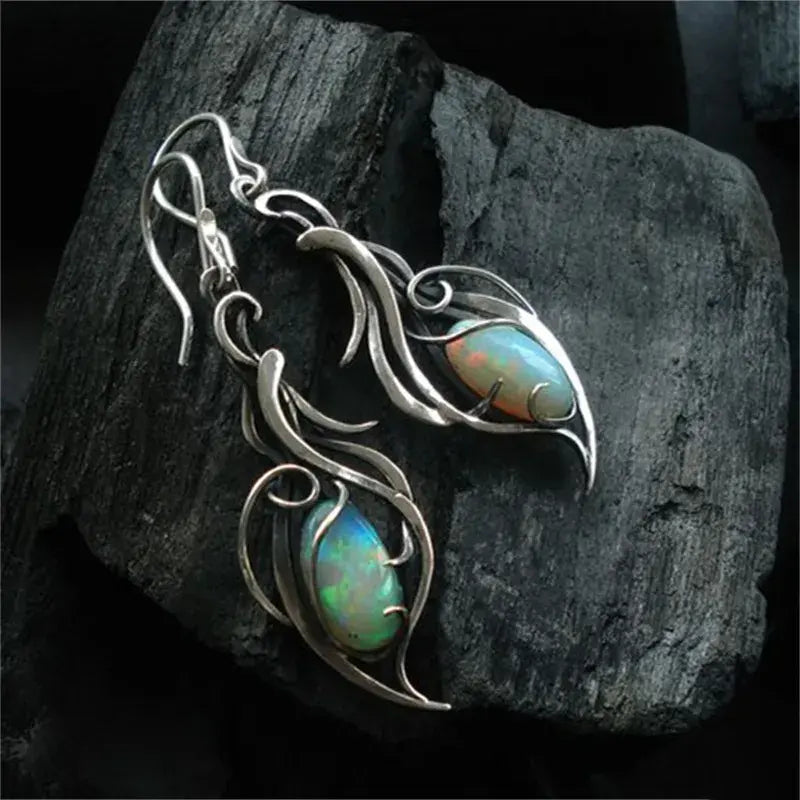 Vintage opal earrings with a filigree leaf design