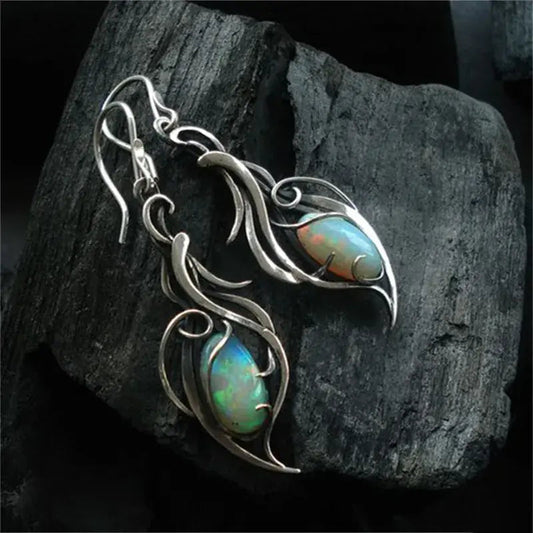Vintage opal earrings with a filigree leaf design