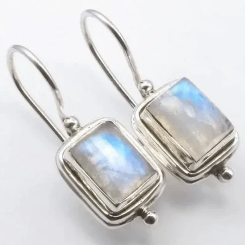 Elegant earrings featuring rectangular moonstone pendants set with diamonds