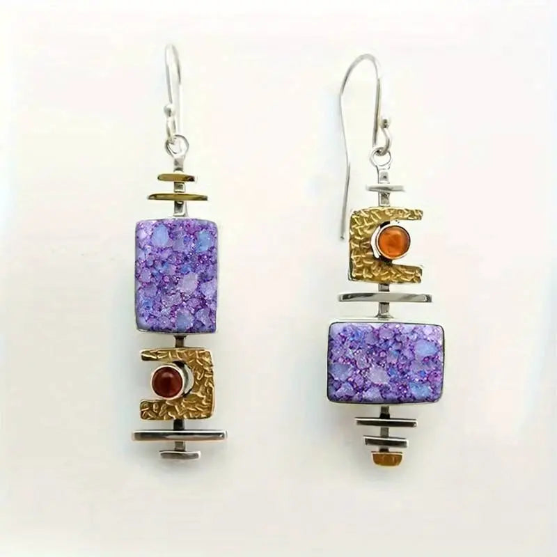 Handmade earrings featuring mottled gemstones and textured metal details