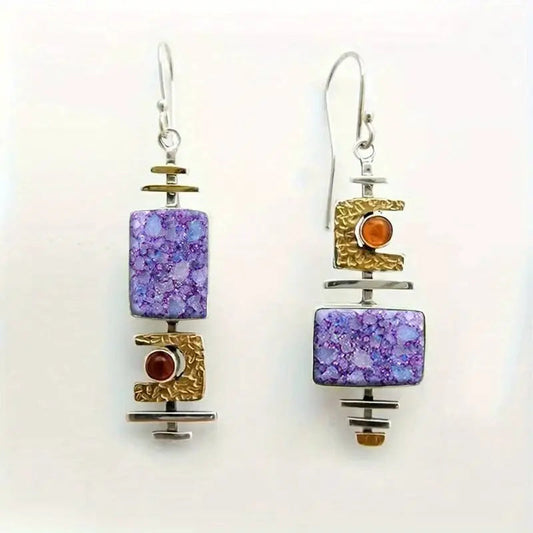 Handmade earrings featuring mottled gemstones and textured metal details