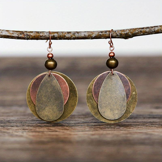 Vintage metal earrings with layered designs in greenish-brown and copper