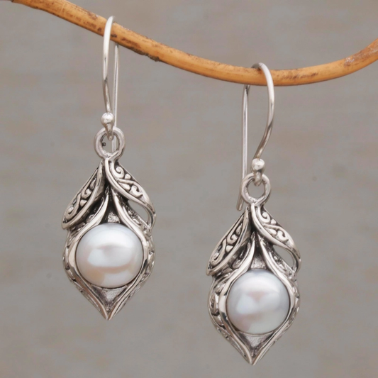 Elegant pearl earrings with a vintage-inspired leaf design