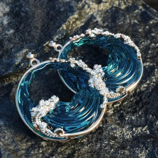 Navy blue wave earrings with glittery spray details