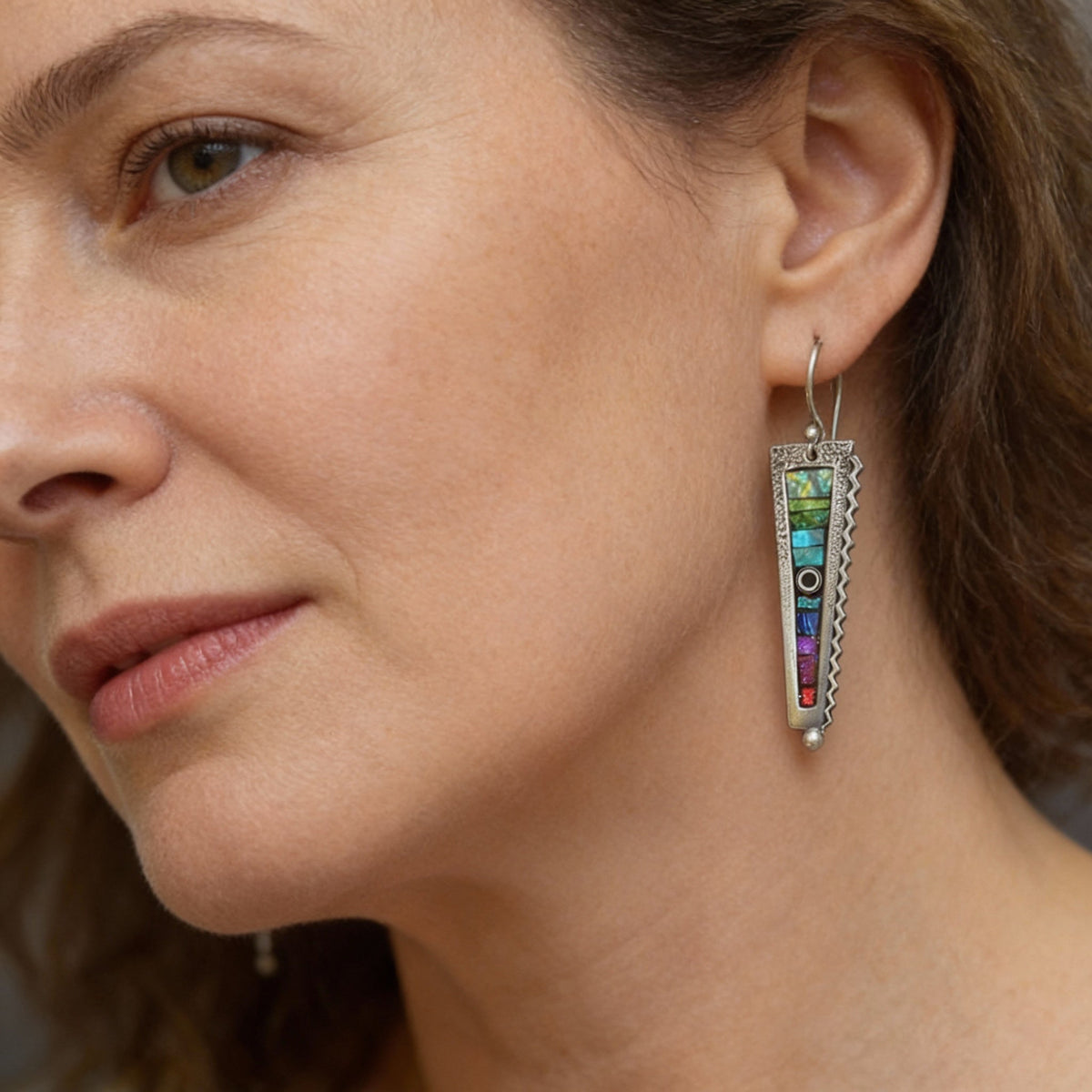 Vintage-inspired earrings set with multicoloured gemstones and featuring a textured setting