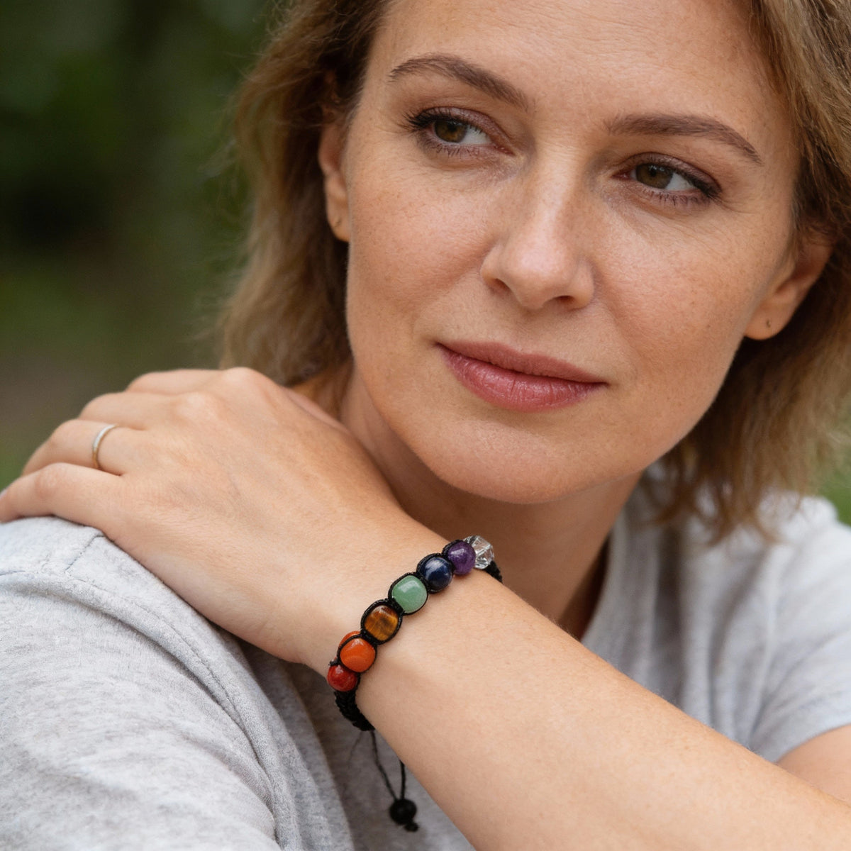 Handmade chakra bracelet with natural stones and an adjustable macramé cord