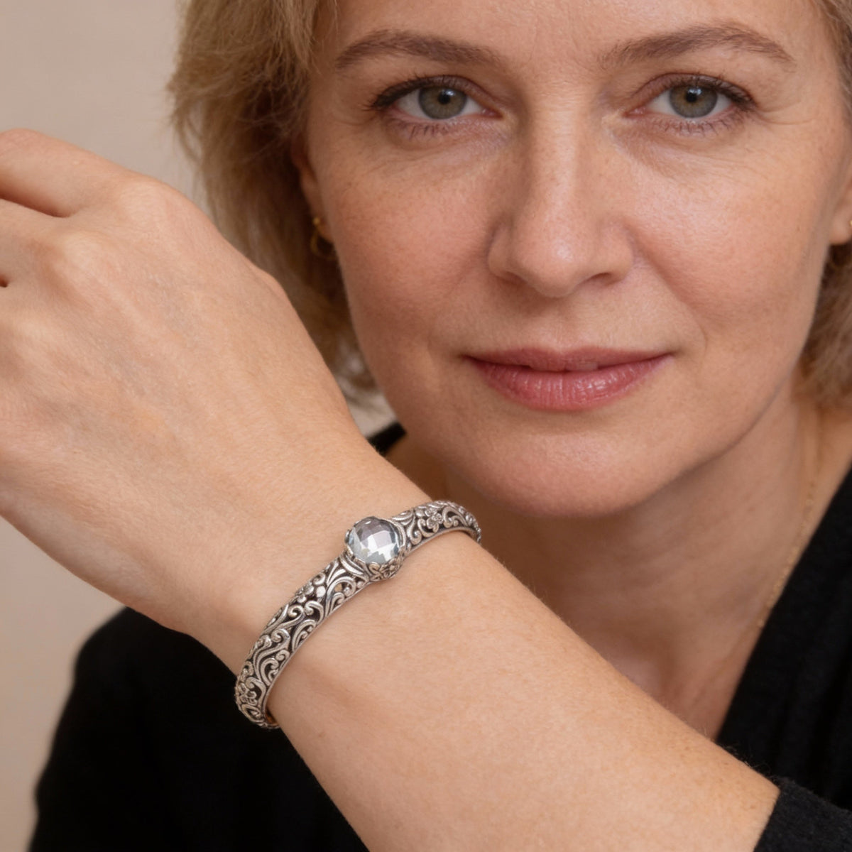 A charming bracelet featuring tendrils, blue topaz and floral motifs