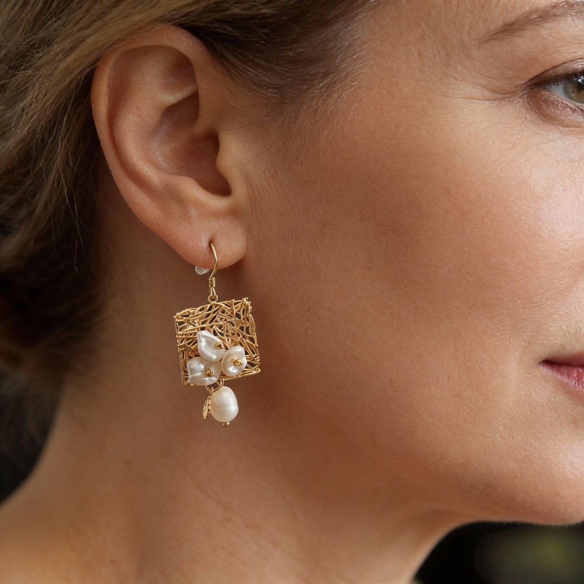 Elegant earrings featuring freshwater pearls and a delicate vintage design