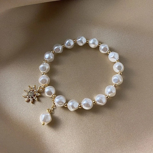 An elegant freshwater pearl bracelet featuring sparkling stars and a pearl necklace
