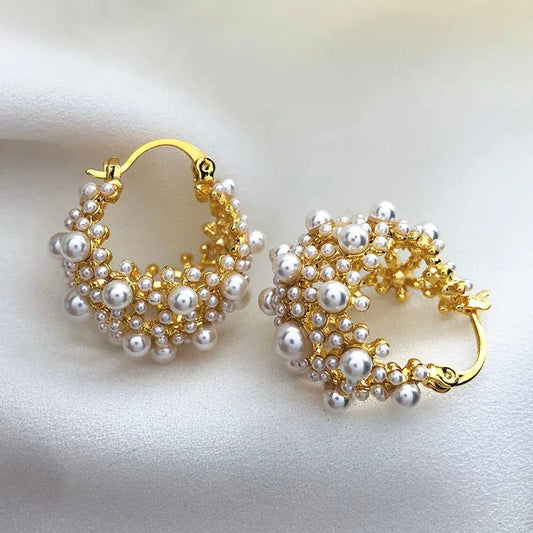 Vintage pearl hoop earrings with a shiny gold finish