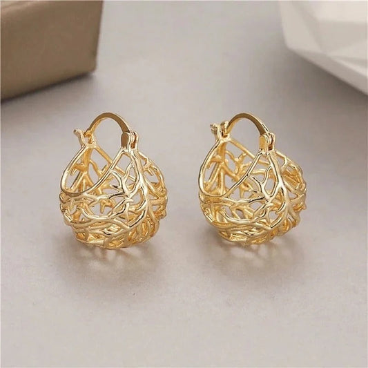 Hoop earrings featuring a filigree foliage design and a dangling pendant