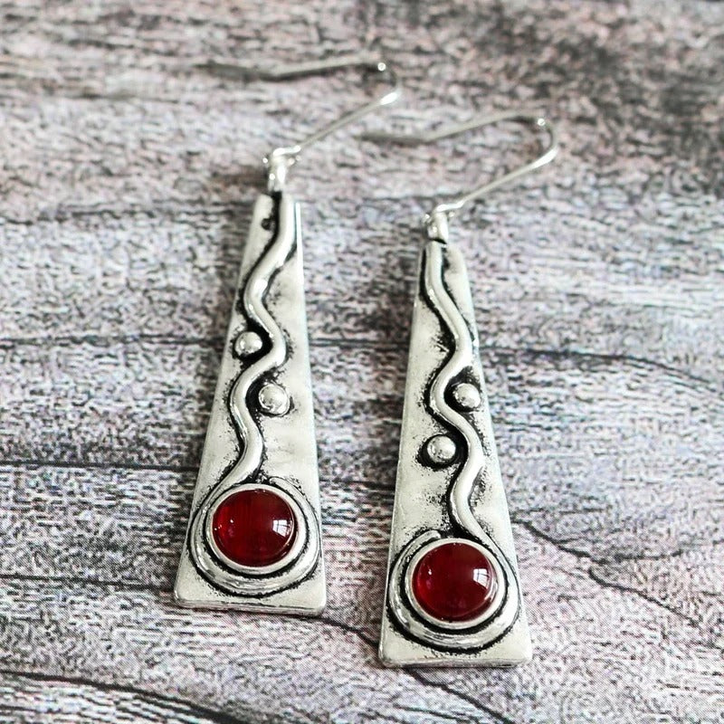 Vintage earrings with a red gemstone and an antique design