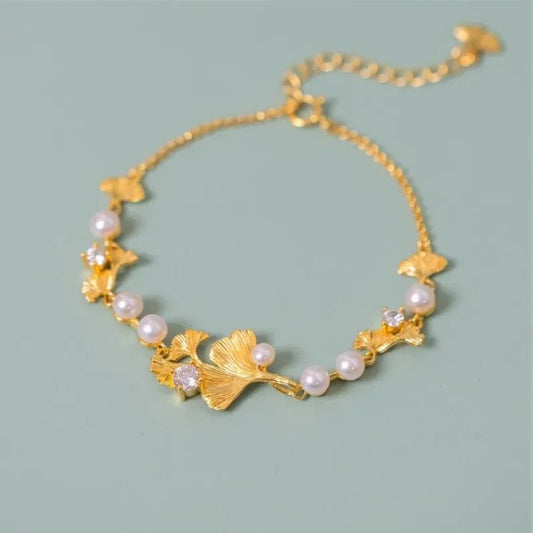 Gold-plated ginkgo leaf bracelet with sparkling pearls and cubic zirconia