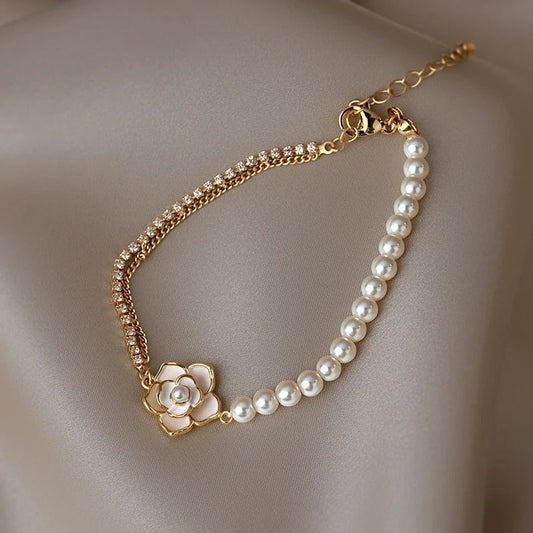 An elegant pearl bracelet with cubic zirconia and a camellia floral design