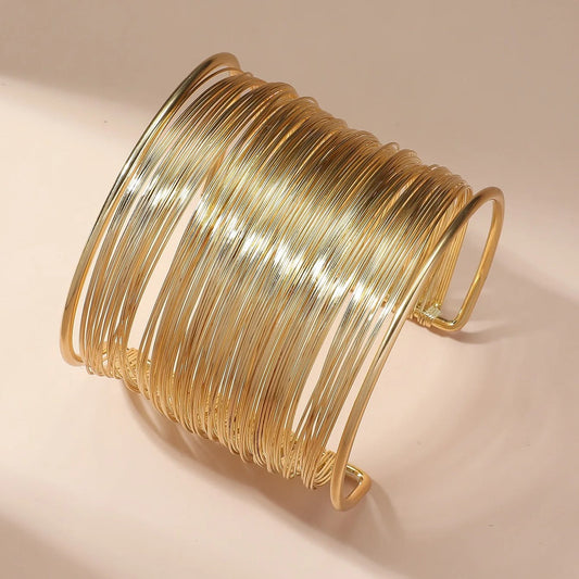 Spiral wrap bracelet with wire wrapping and a multi-layered design