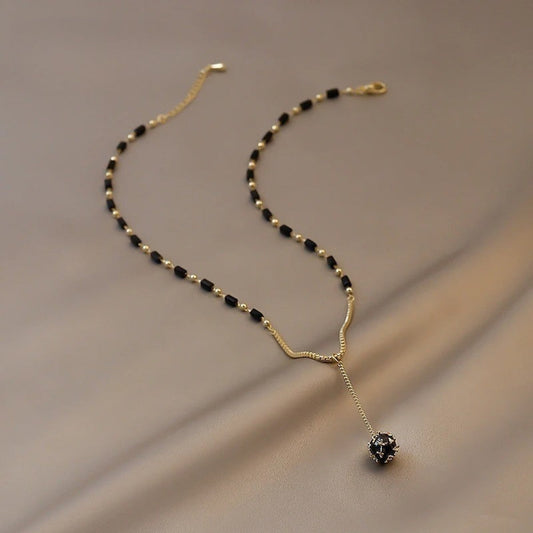Elegant Y-Necklace with Black Beads and Unique Pendant