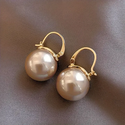Elegant pearl earrings with a delicate bezel, perfect for special occasions
